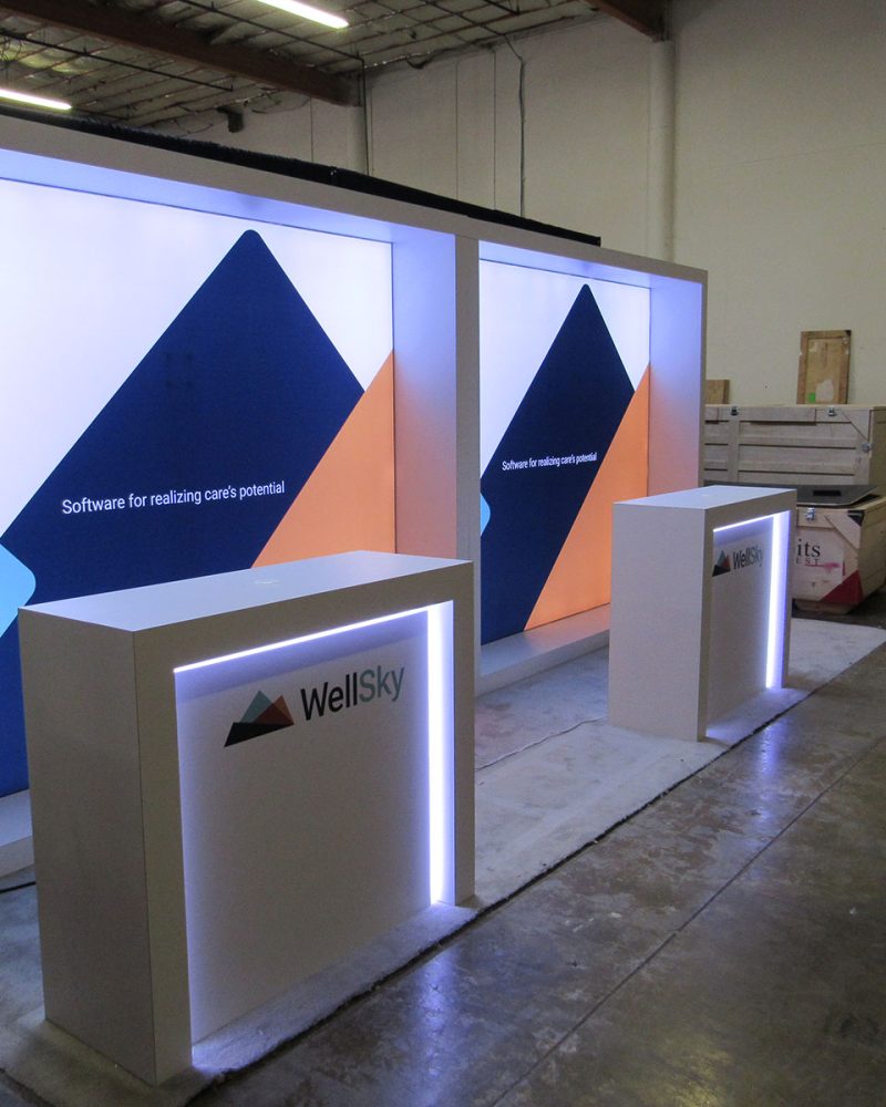 Example 10×20 Custom Exhibit with Backlit Laminated Walls, Custom Edge Glow Counters